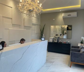 Recepção da unidade Fismatek Cisper com balcão de mármore e lustre de cristal